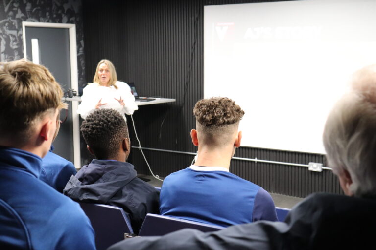 Luton Town academy players watch as Roseann Taylor from the VERU gives them a talk about knife crime
