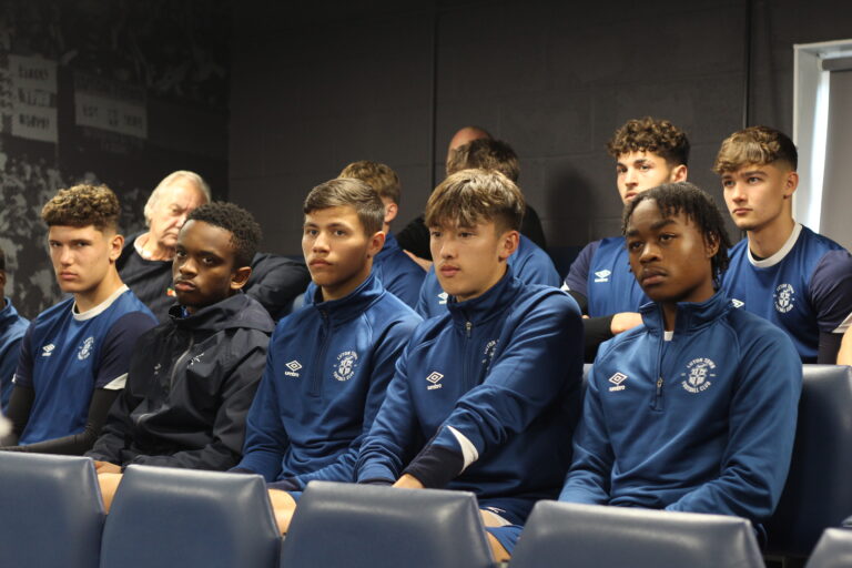Luton Town academy players watch as Roseann Taylor from the VERU gives them a talk about knife crime